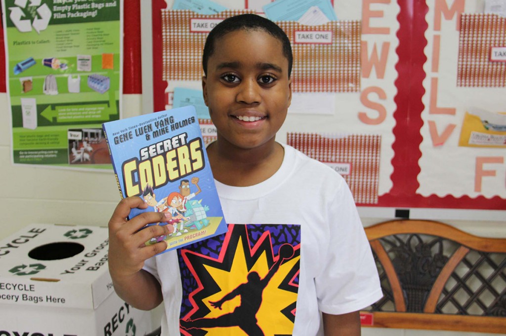 Image of a Parkway Elementary student holding up a favorite book